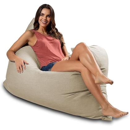 Woman sitting by the pool on the Piper Outdoor Bean Bag Pillow - Sunbrella
