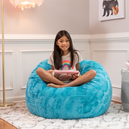 Kid sitting on the Saxx 3' Faux Fur Bean Bag in cuddlefur maui