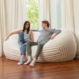 Couple sitting on 7ft Lounger in mondo white fur