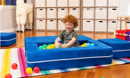 Child playing with Zipline Toddler's Convertible Loveseat converted to ball pit